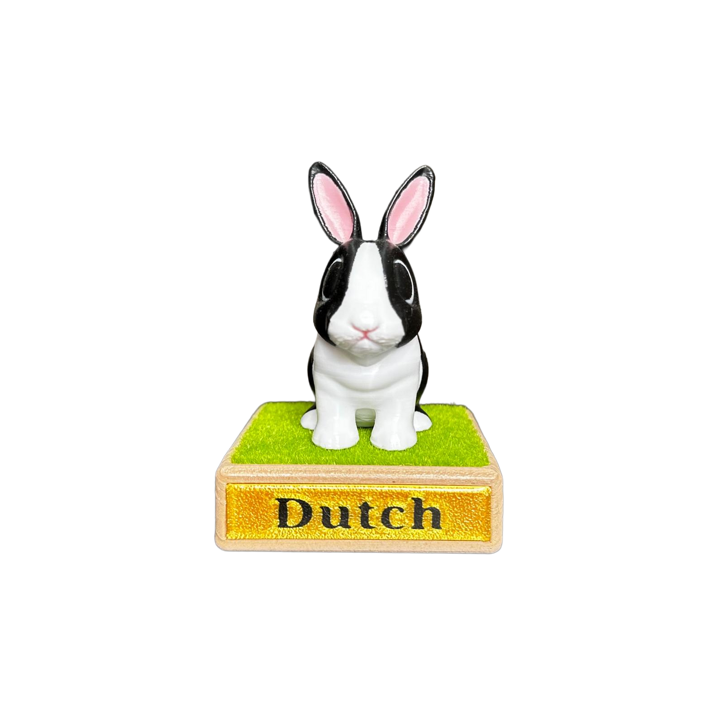 Small black and white rabbit figurine on a wooden base with 'Dutch' text