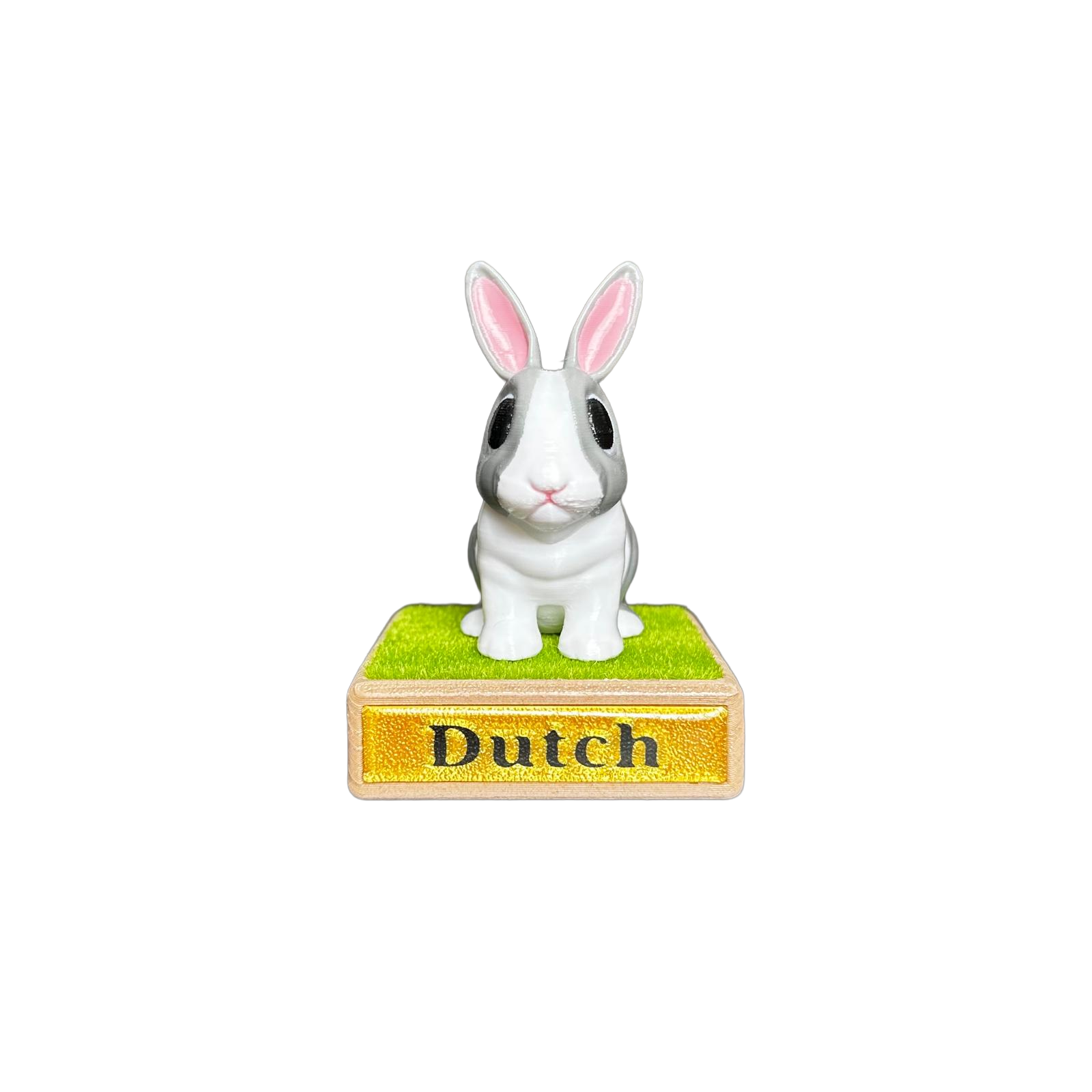 White and gray rabbit figurine on a green base with 'Dutch' label 
