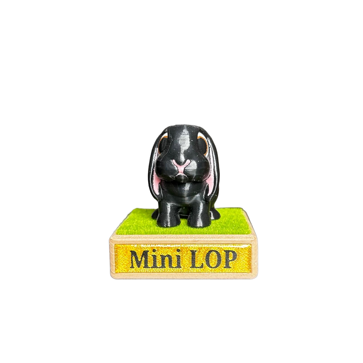 Black mini lop rabbit figurine on a green base with 'Mini LOP' text 